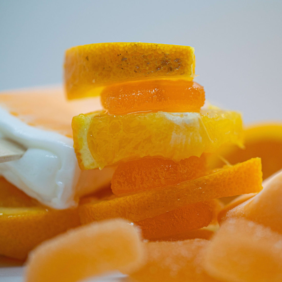 Delicious orange slices and gummy candies stacked together for a vibrant dessert display.