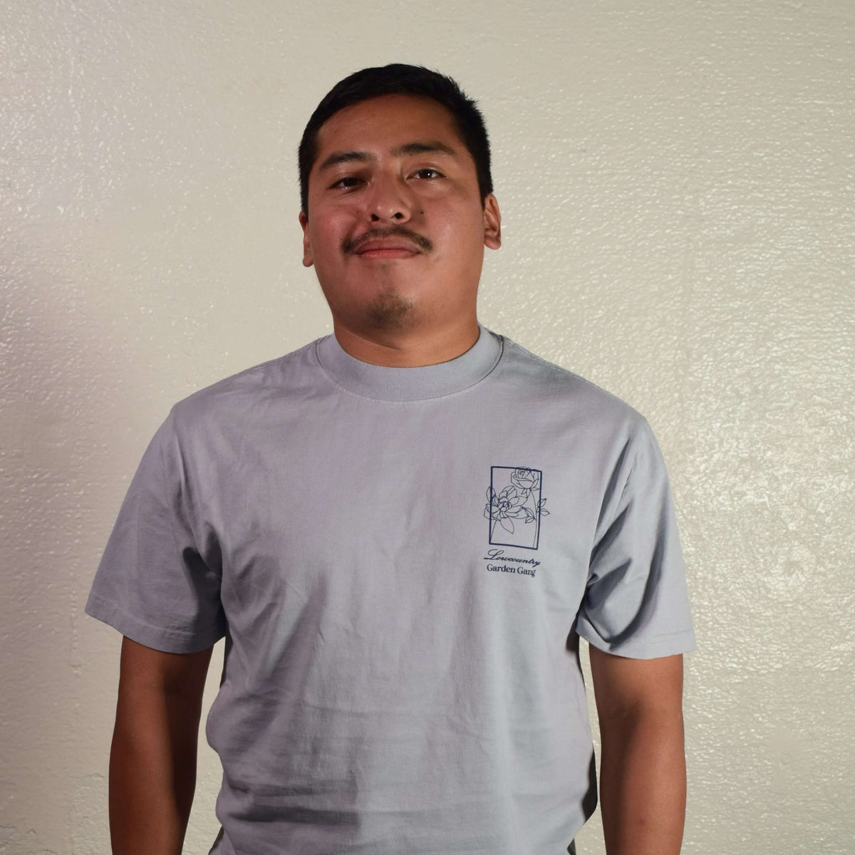 Man wearing a Lowcountry Garden Gang tee shirt, showcasing comfort and style in everyday wear.