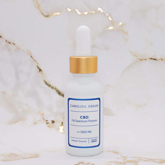 Full Spectrum 1500mg CBD Tincture bottle with dropper on marble background.